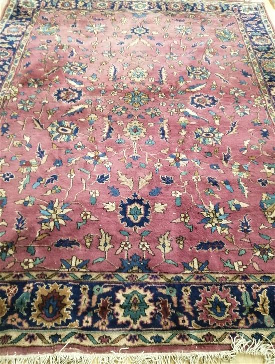 A Persian style plum ground carpet 245 x 295cm